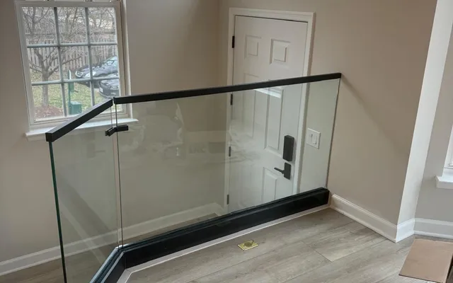 Frameless glass railing on an entry landing