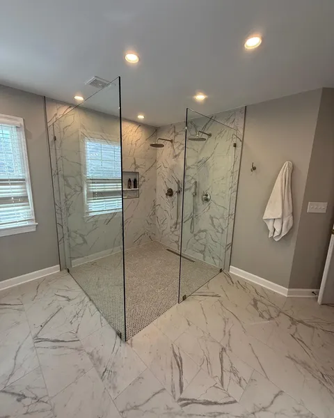 Frameless glass shower enclosure